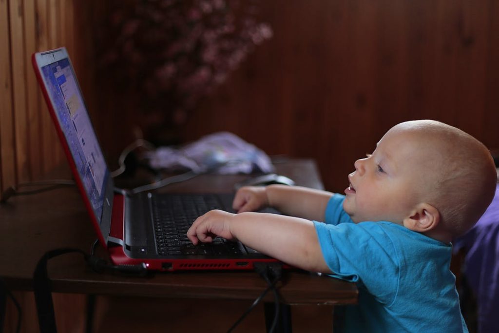 Baby typing on a computer
